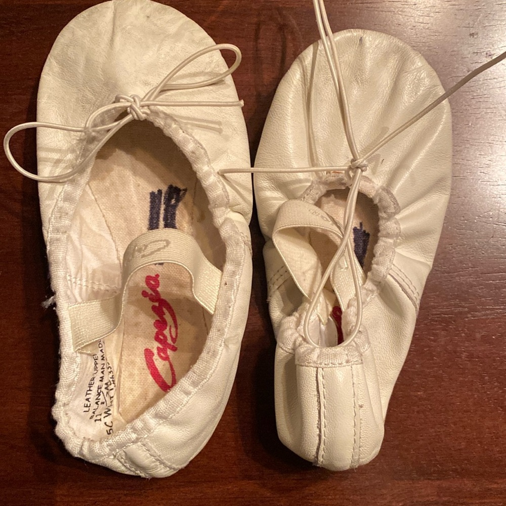 Girls white ballet shoes.